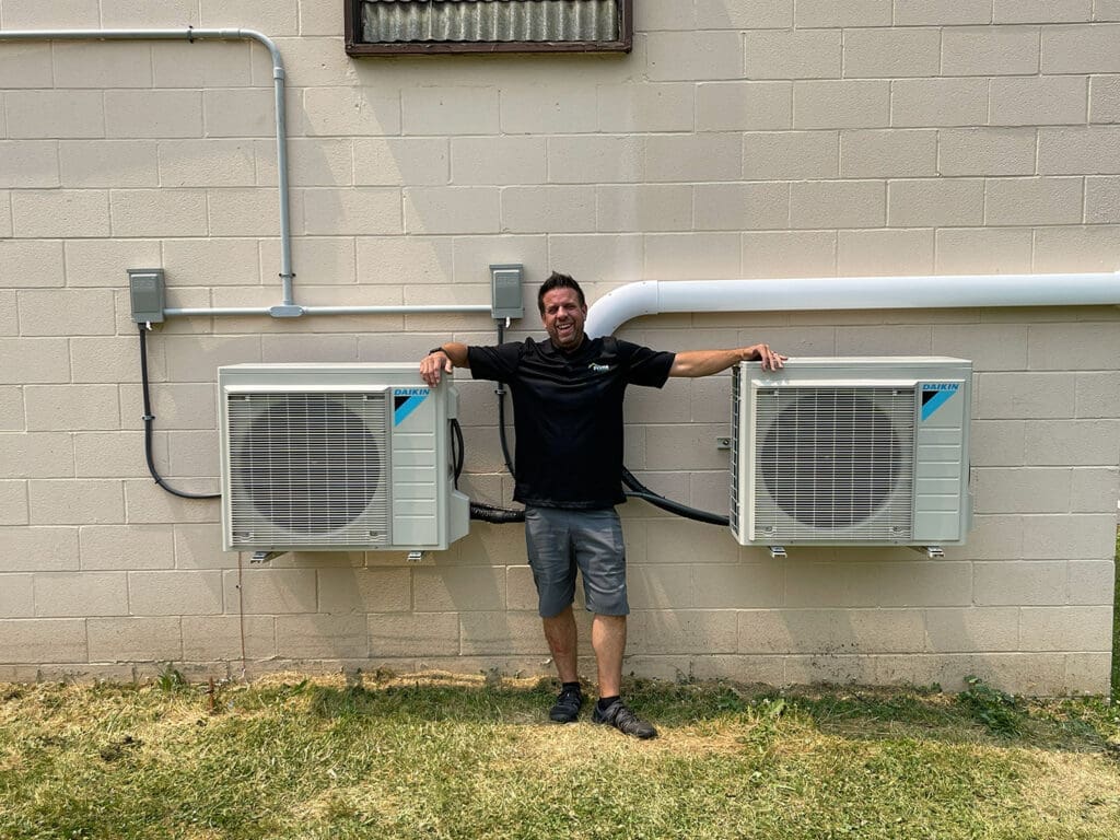 Prime Home HVAC technician with multi-zone outdoor HVAC equipment.