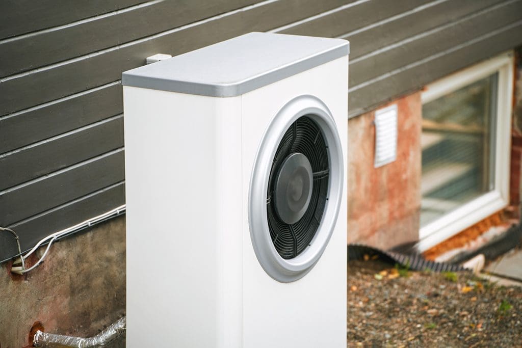 An external geothermal heat pump next to a home geothermal heating unit in York, PA